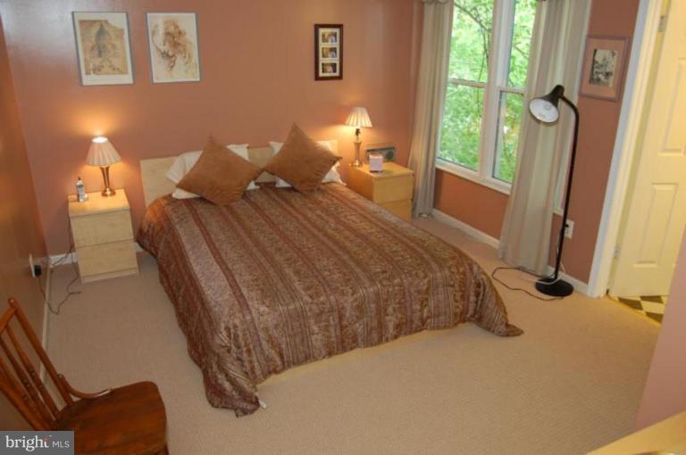 13114 Broadmore Road Silver Spring, MD 20904 - Photo 8 of 22 a bed sitting in a bedroom next to a window