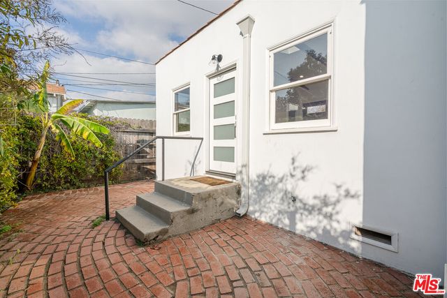 a spacious bedroom with a bed and a window
