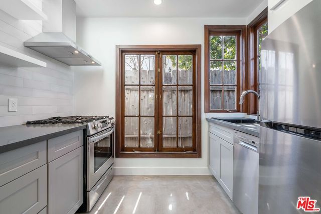a kitchen with stainless steel appliances granite countertop a stove and a sink