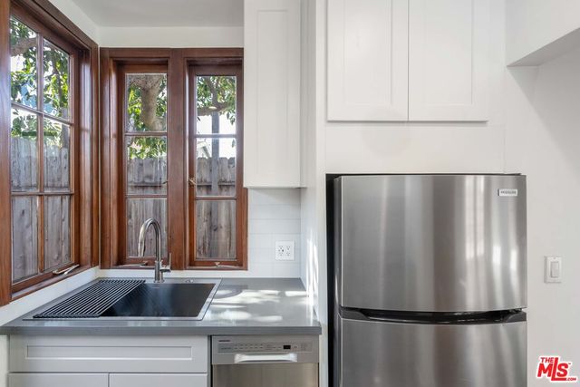 a kitchen with refrigerator and window