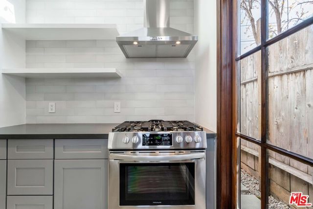 a stove top oven sitting inside of a kitchen