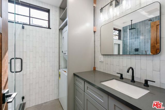 a bathroom with a granite countertop sink mirror and double
