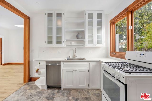 a kitchen with stainless steel appliances granite countertop a stove and a sink