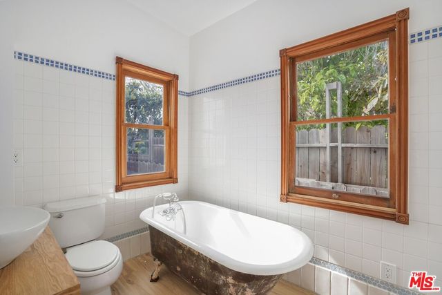 a bathroom with a toilet a sink and a window