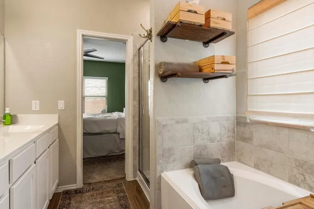 a bathroom with a double vanity sink and shower