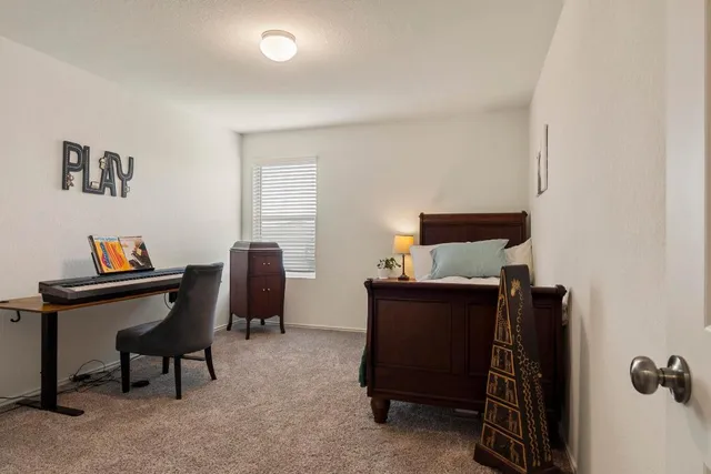 a bedroom with a bed and a painting on the wall