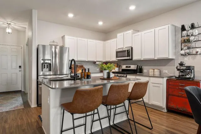 a kitchen with sink a stove and cabinets