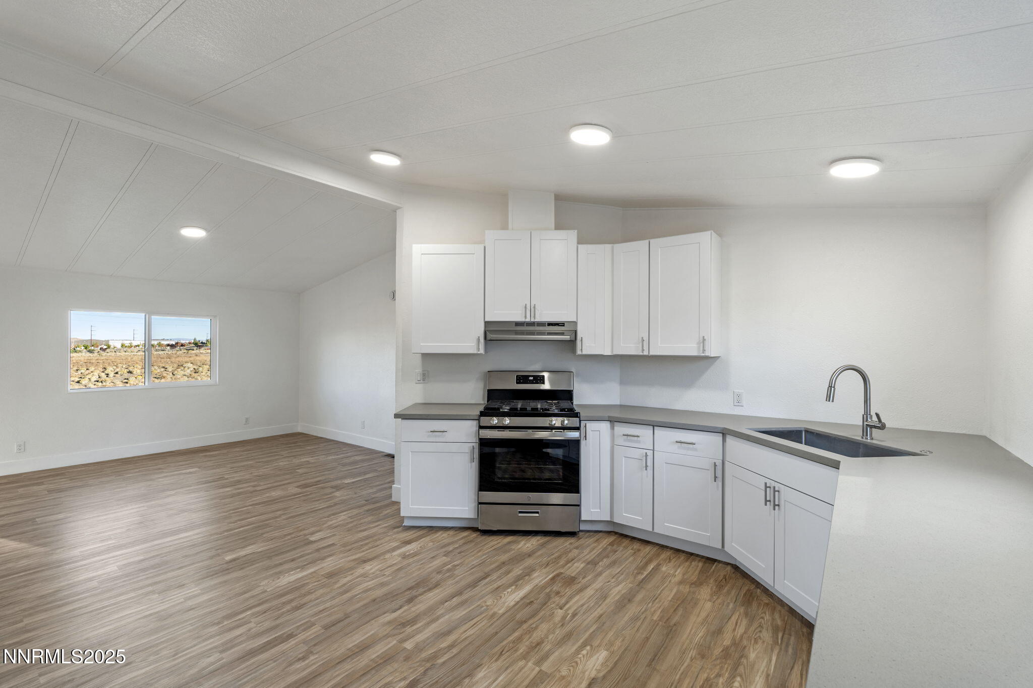 230 Medgar Avenue Reno, NV 89506 - Photo 12 of 43 a kitchen with stainless steel appliances granite countertop a stove a sink and a microwave