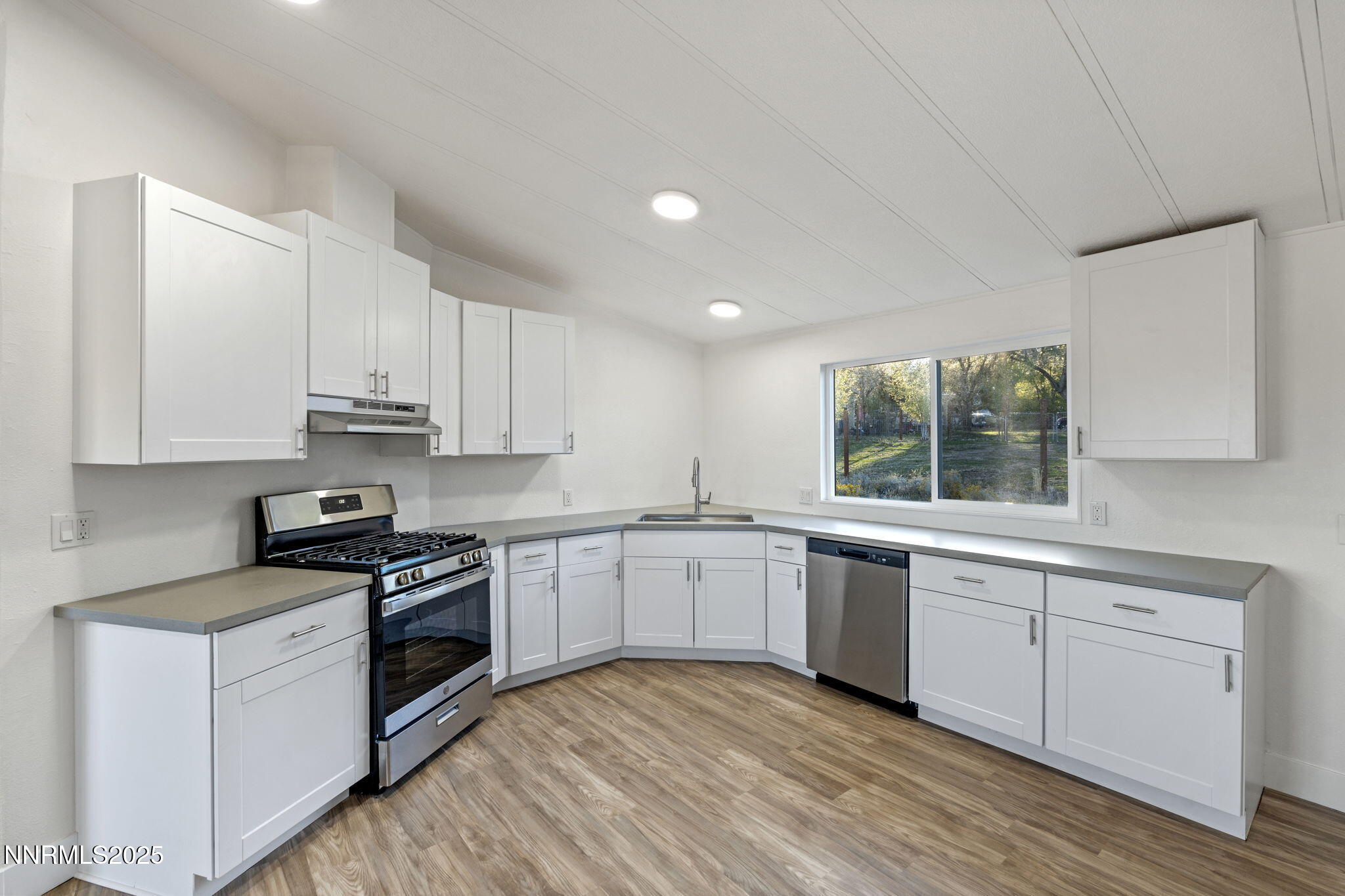 230 Medgar Avenue Reno, NV 89506 - Photo 13 of 43 a kitchen with granite countertop white cabinets and white appliances