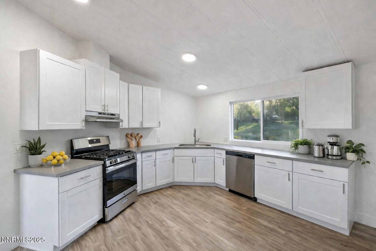 230 Medgar Avenue Reno, NV 89506 - Photo 14 of 43 a kitchen with appliances a sink and cabinets