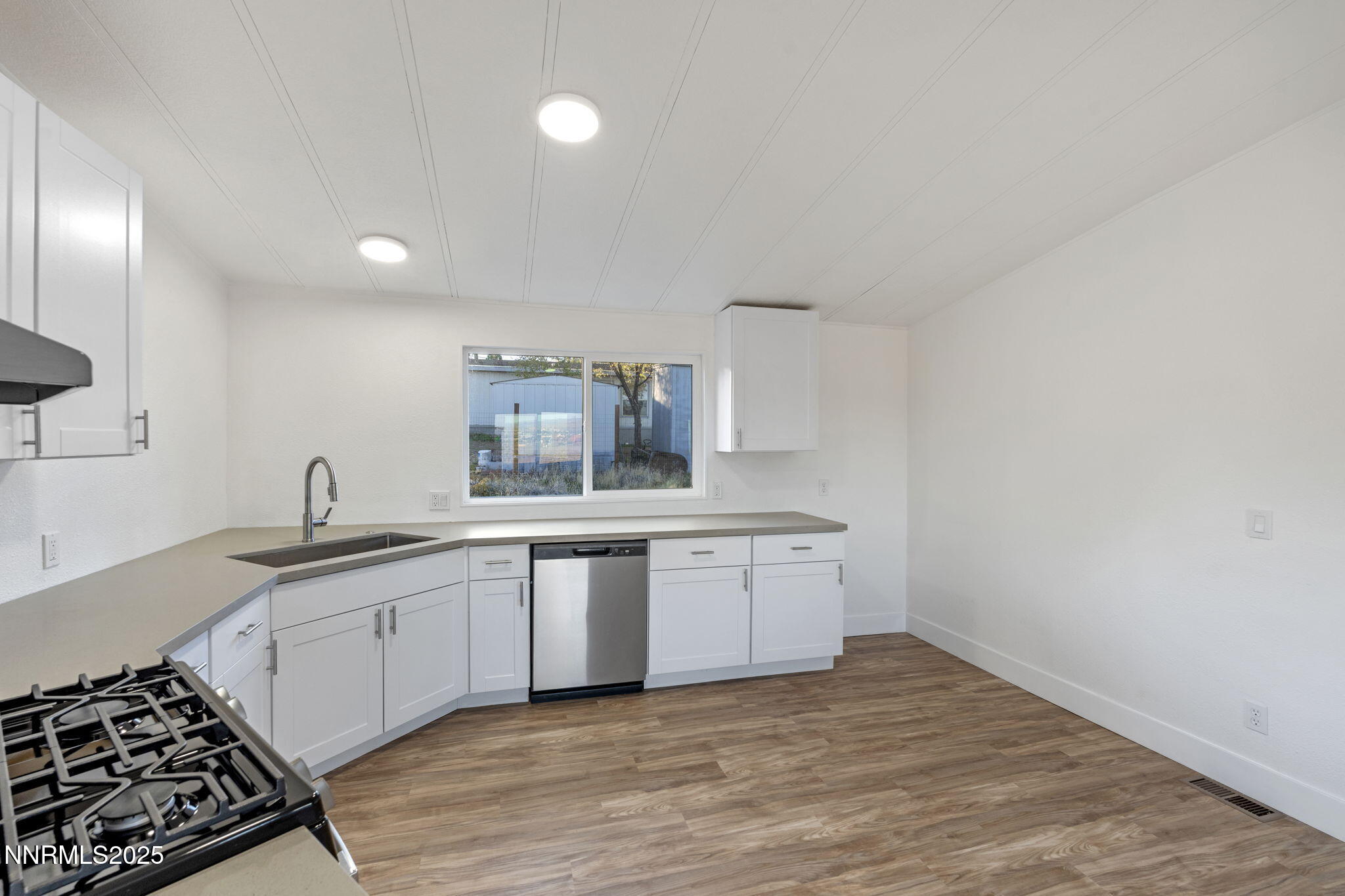230 Medgar Avenue Reno, NV 89506 - Photo 15 of 43 a kitchen with granite countertop a sink stainless steel appliances and cabinets