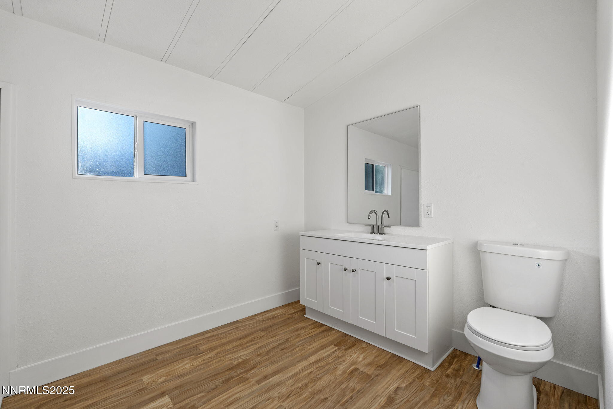 230 Medgar Avenue Reno, NV 89506 - Photo 16 of 43 a bathroom with a sink a toilet and mirror