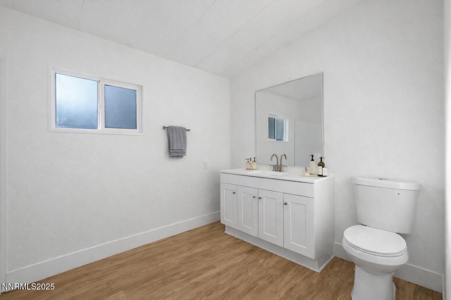 230 Medgar Avenue Reno, NV 89506 - Photo 17 of 43 a bathroom with a sink a toilet and mirror