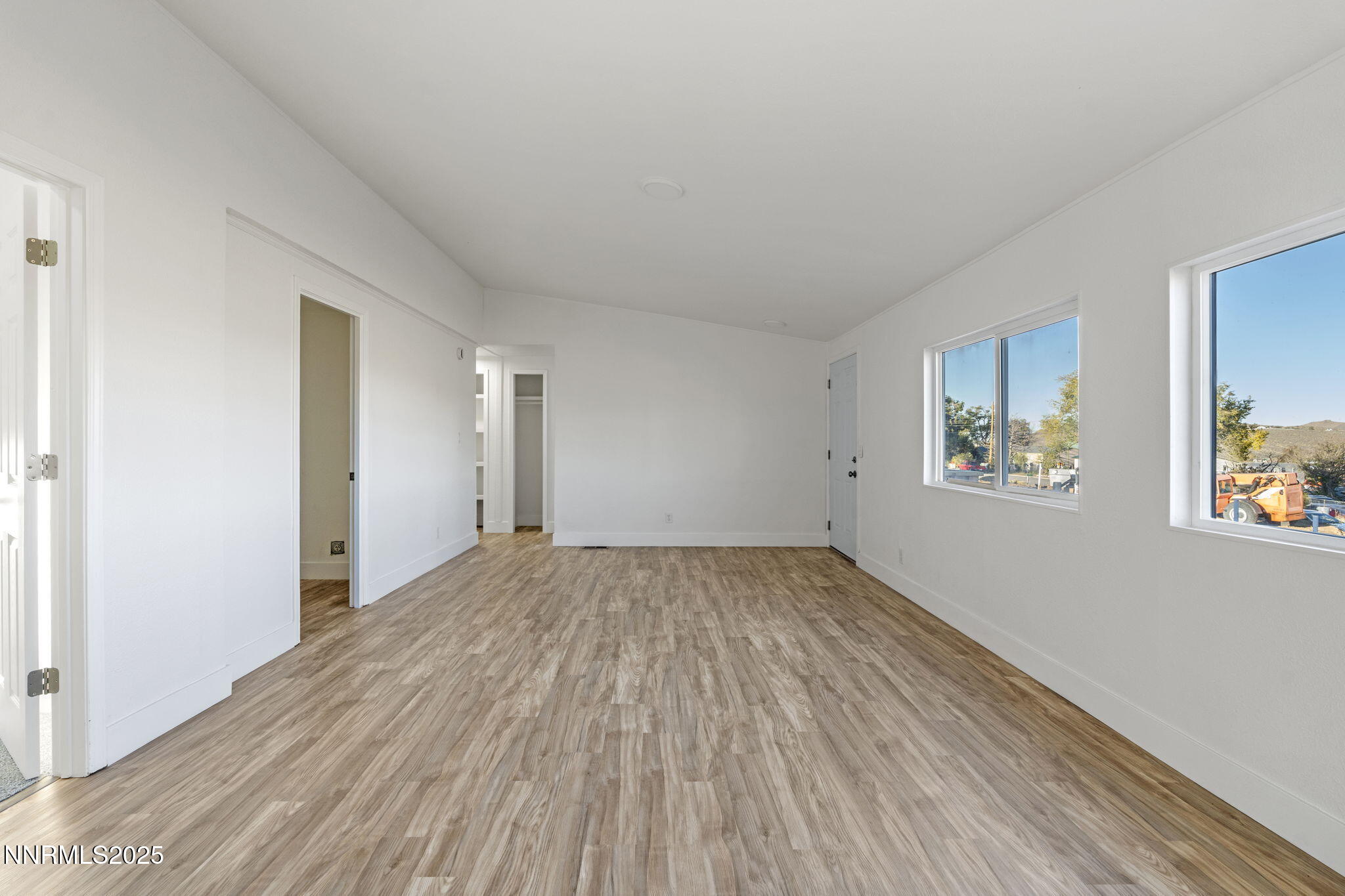 230 Medgar Avenue Reno, NV 89506 - Photo 7 of 43 an empty room with wooden floor and windows