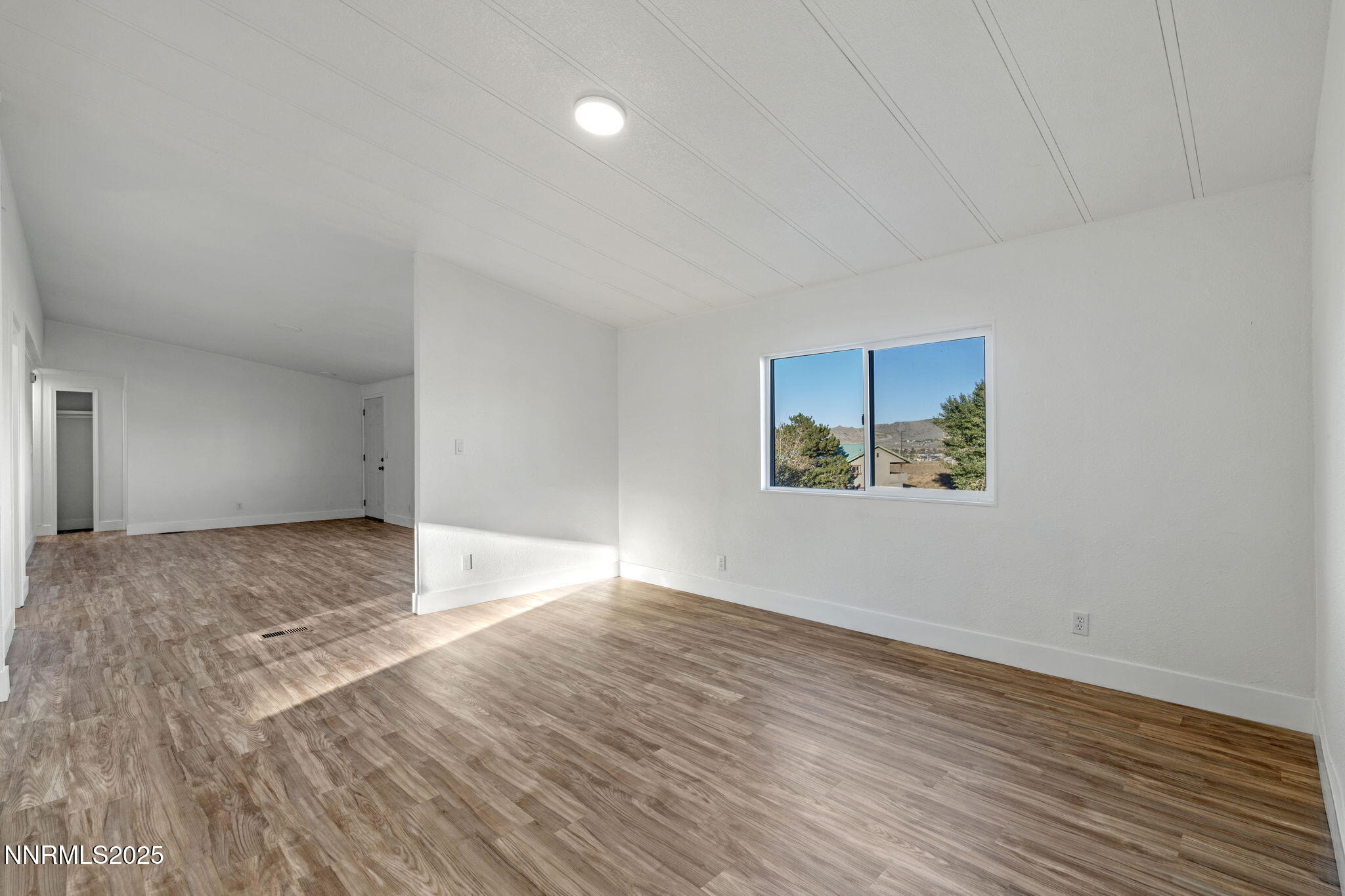 230 Medgar Avenue Reno, NV 89506 - Photo 9 of 43 a view of an empty room with wooden floor and window