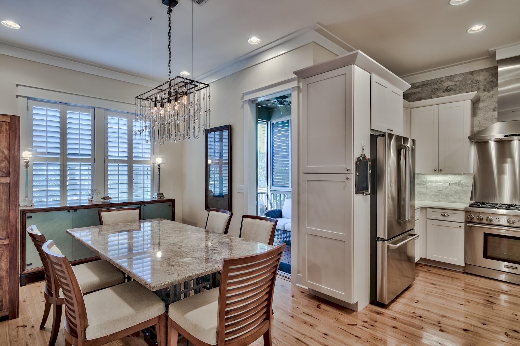 25 South Summit Drive Santa Rosa Beach, FL 32459 - Photo 16 of 46 a kitchen with refrigerator cabinets dining table and wooden floor