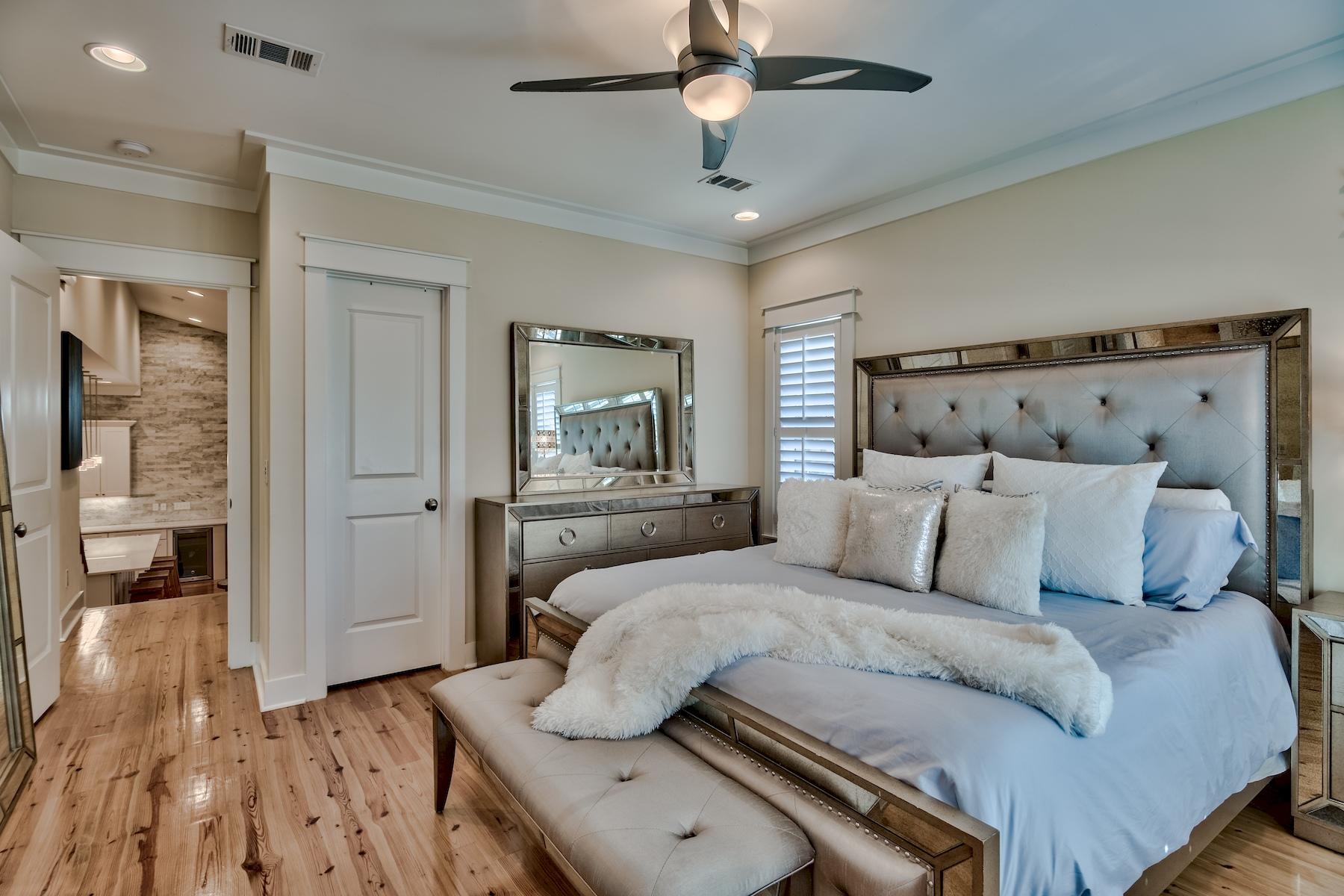 25 South Summit Drive Santa Rosa Beach, FL 32459 - Photo 27 of 46 a bedroom with a large bed and a chandelier