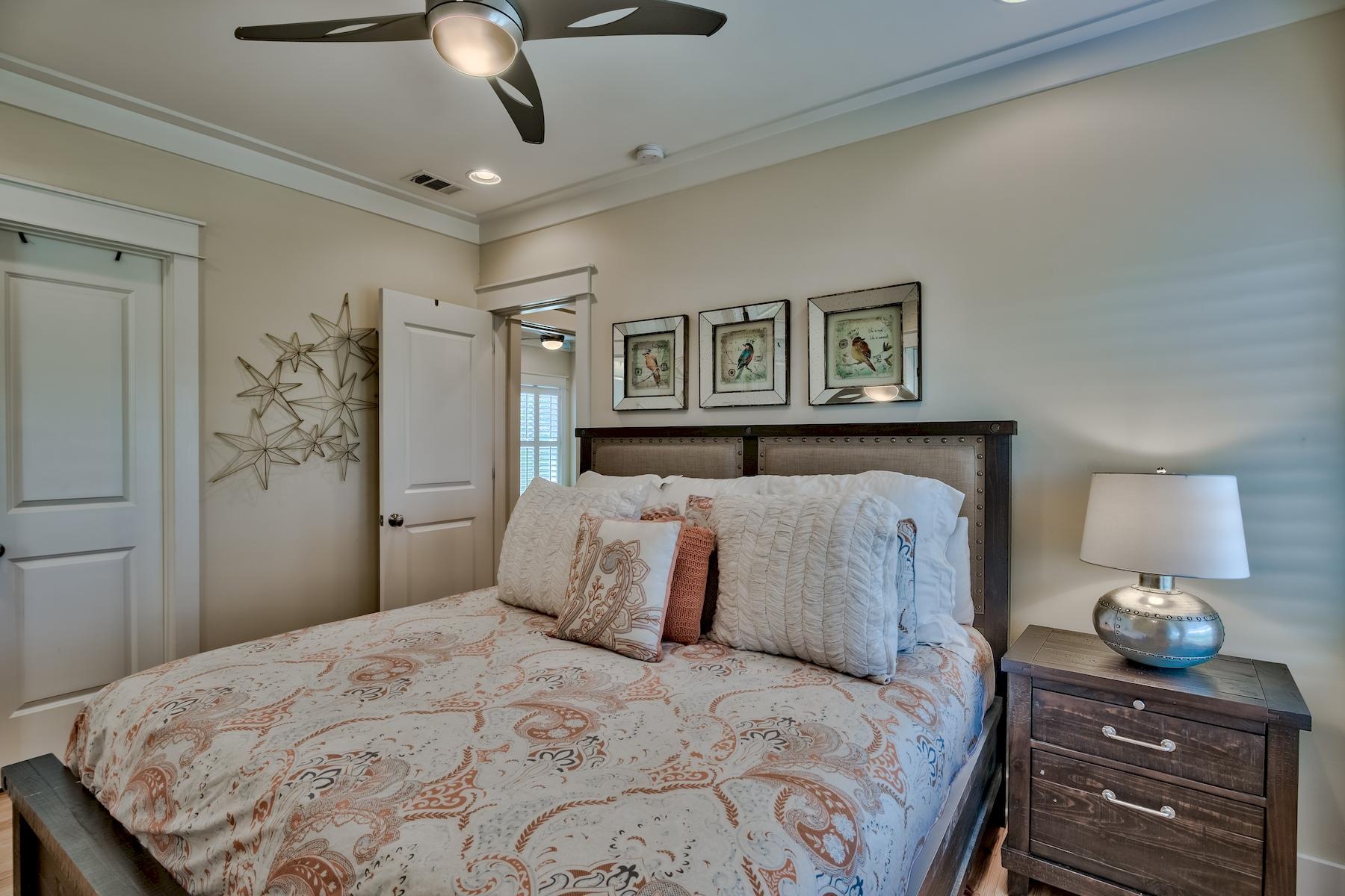 25 South Summit Drive Santa Rosa Beach, FL 32459 - Photo 30 of 46 a bedroom with a bed and wooden floor