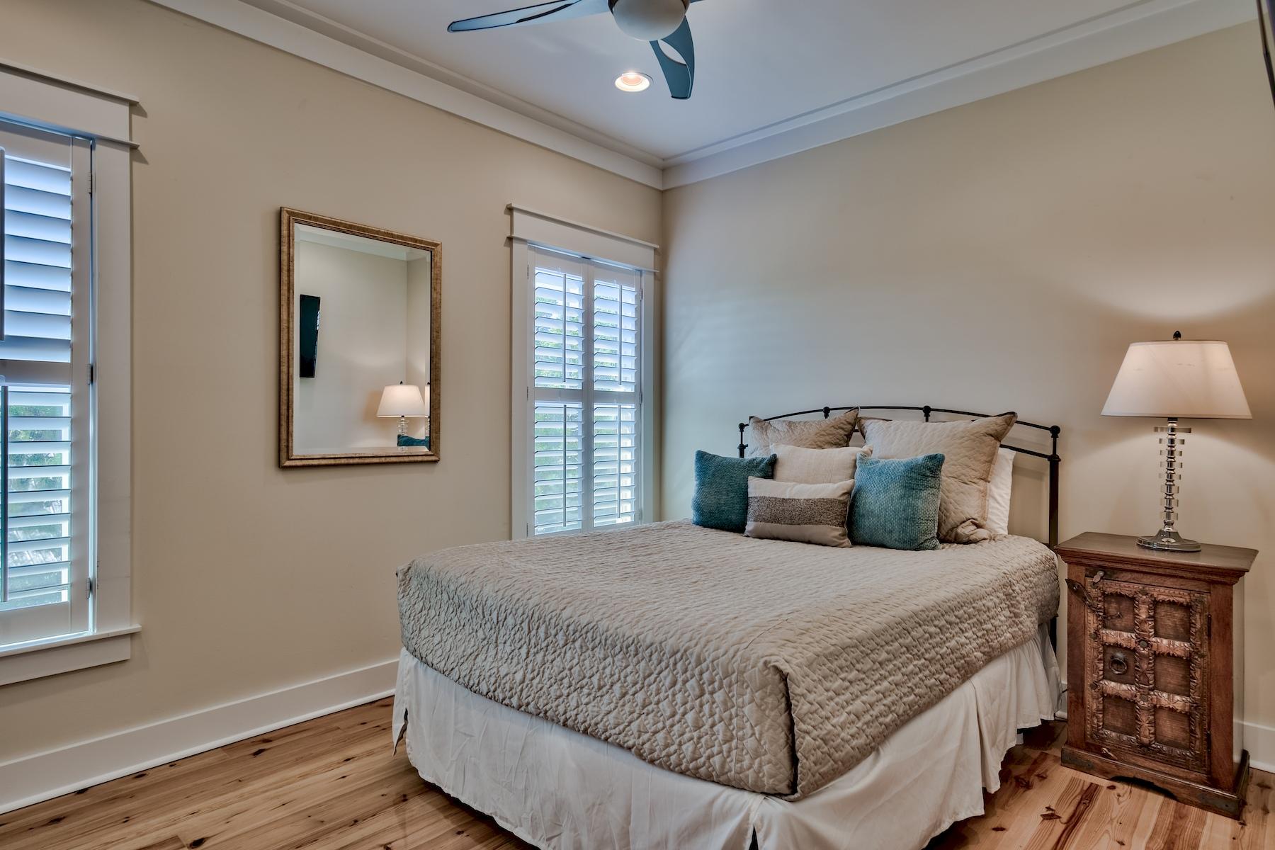 25 South Summit Drive Santa Rosa Beach, FL 32459 - Photo 34 of 46 a bedroom with a bed and wooden floor