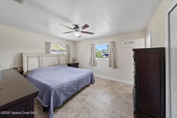 a bedroom with a bed closet and a window