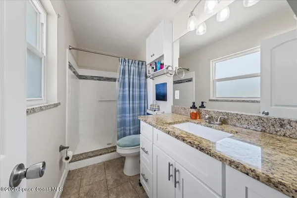 a bedroom with furniture and a flat screen tv