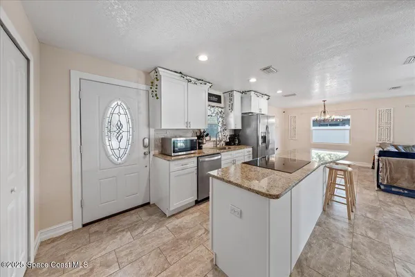 a kitchen with appliances cabinets and a sink