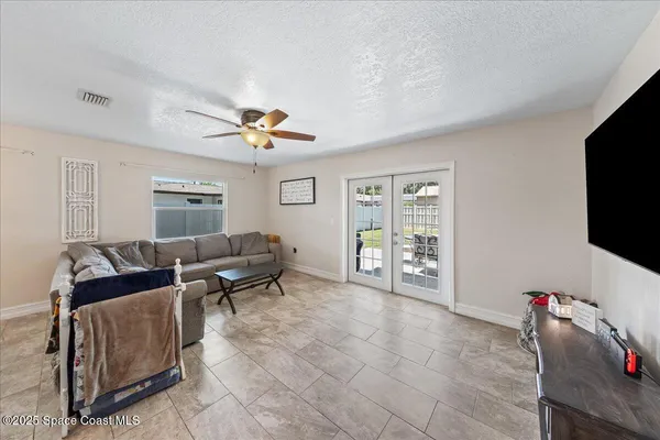 a living room with furniture and a kitchen view