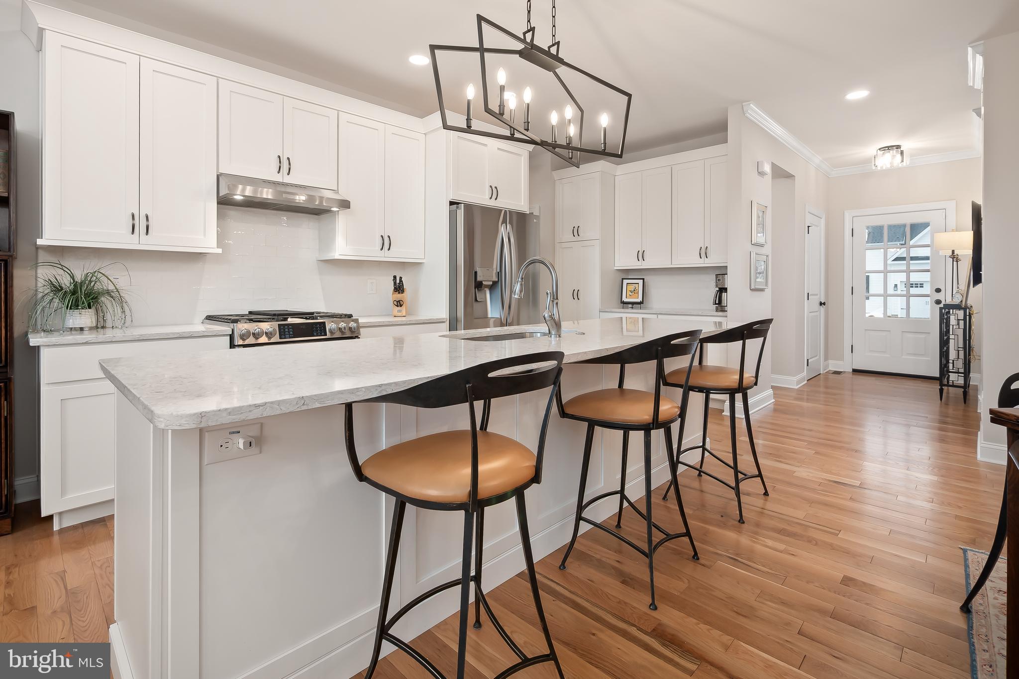 4459 Old Saucon Road Bethlehem, PA 18015 - Photo 12 of 39 a kitchen with stainless steel appliances a table chairs refrigerator and microwave