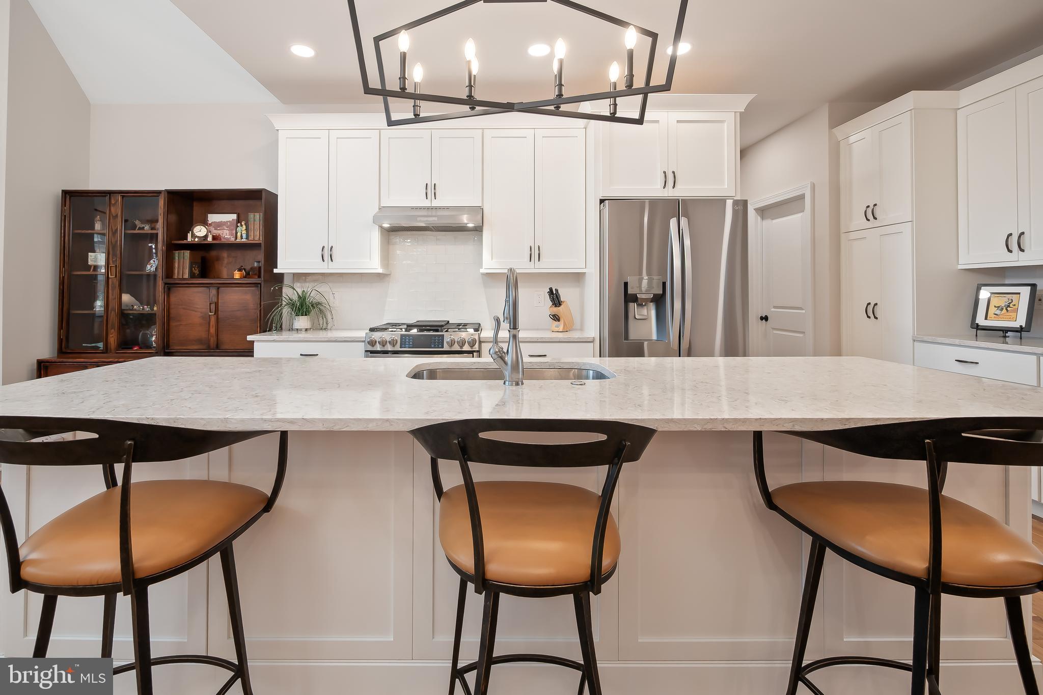 4459 Old Saucon Road Bethlehem, PA 18015 - Photo 13 of 39 a kitchen with stainless steel appliances granite countertop a sink a stove a refrigerator and island with wooden floor