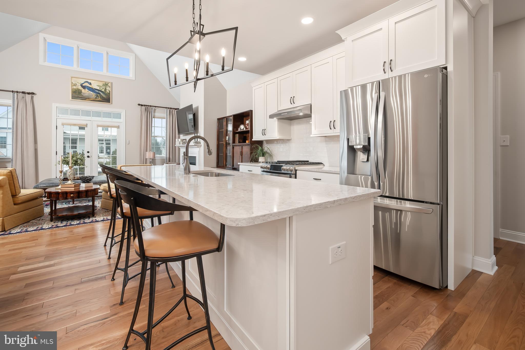 4459 Old Saucon Road Bethlehem, PA 18015 - Photo 14 of 39 a kitchen with stainless steel appliances granite countertop a refrigerator a sink dishwasher a stove a dining table and chairs with wooden floor