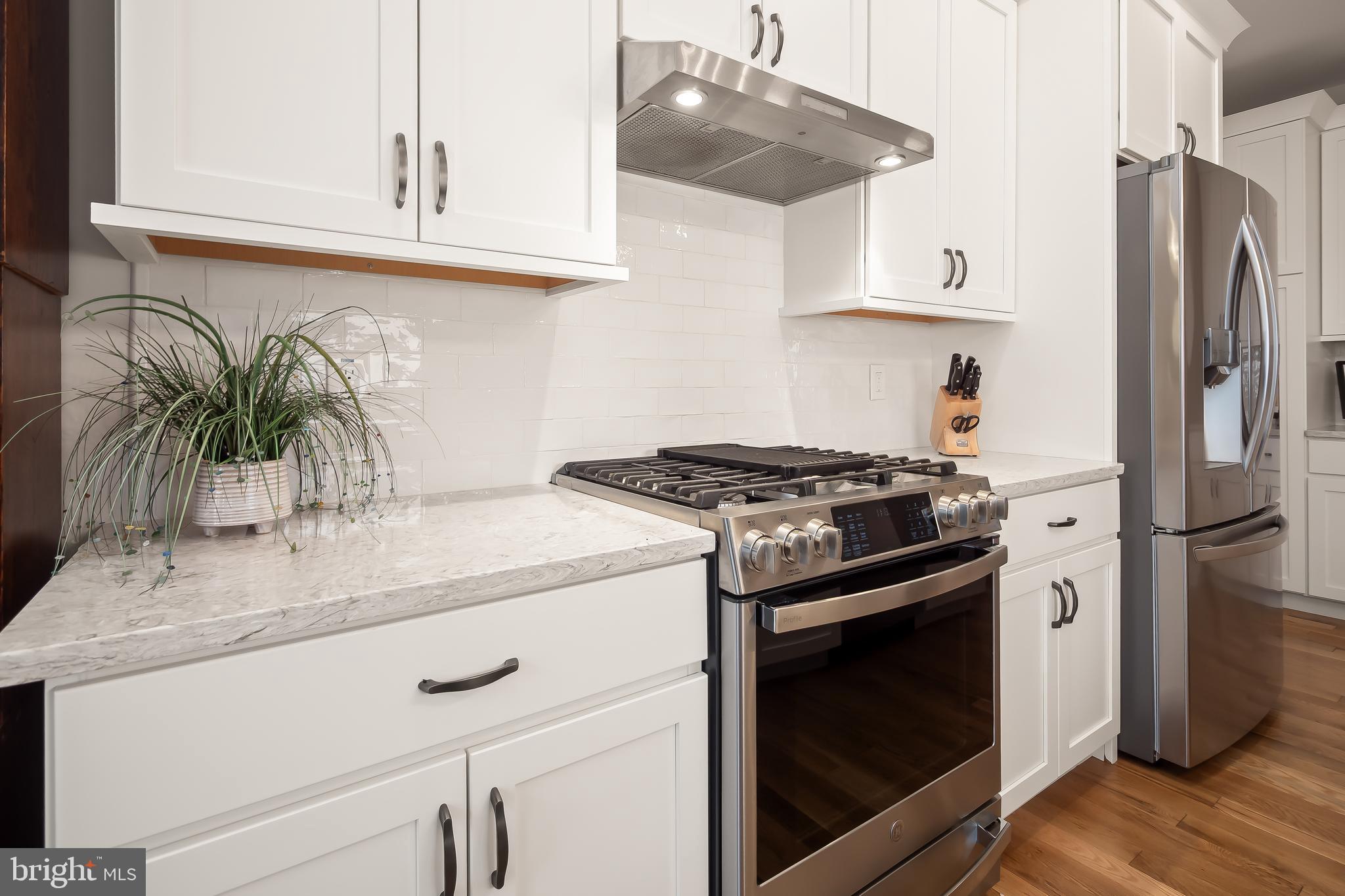 4459 Old Saucon Road Bethlehem, PA 18015 - Photo 15 of 39 a kitchen with granite countertop a stove and a white refrigerator