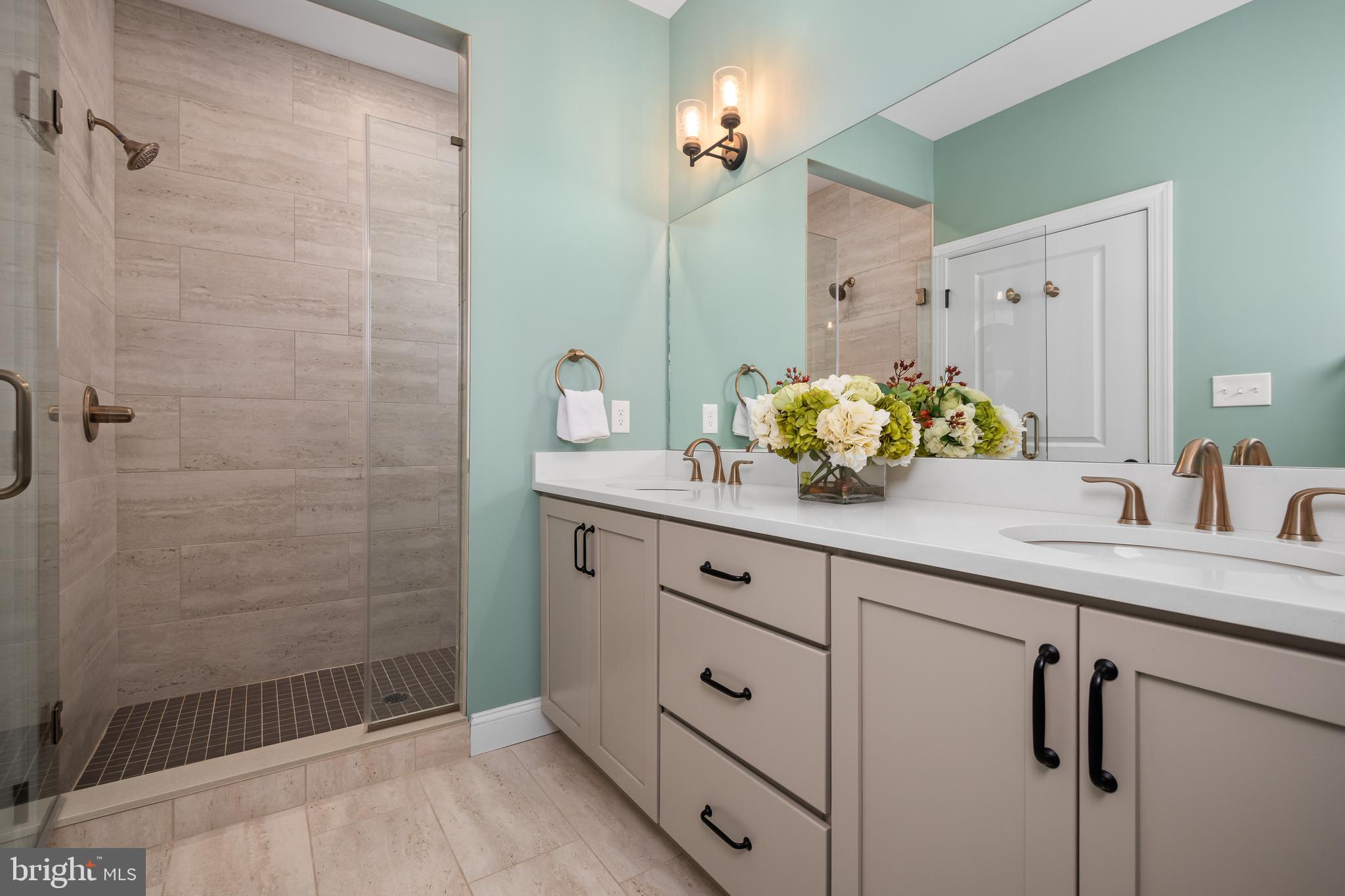 4459 Old Saucon Road Bethlehem, PA 18015 - Photo 24 of 39 a bathroom with a granite countertop sink a mirror and shower