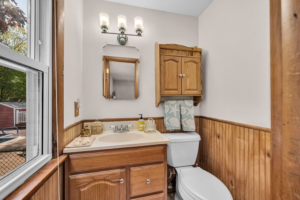 163 Cedar Road Longmeadow, MA 01106 - Photo 17 of 39 a bathroom with a toilet a sink and mirror