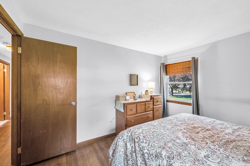 163 Cedar Road Longmeadow, MA 01106 - Photo 21 of 39 a bedroom with a bed and wooden floor