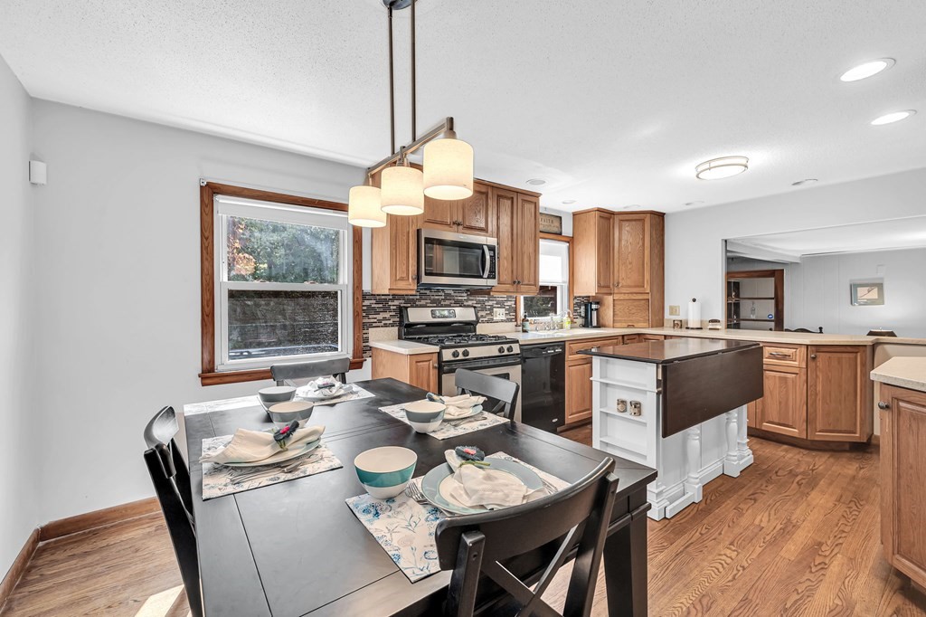 163 Cedar Road Longmeadow, MA 01106 - Photo 7 of 39 a open dining room with stainless steel appliances kitchen island granite countertop a stove a kitchen island a dining table and chairs