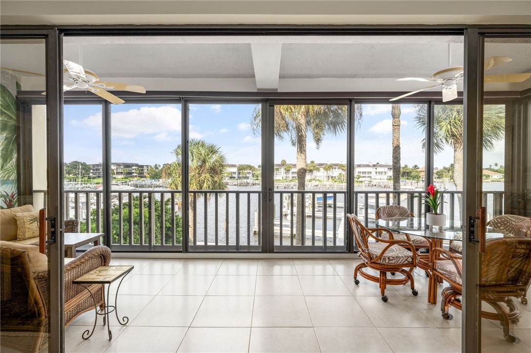 1875 Bay Road, Unit 215H Vero Beach, FL 32963 - Photo 1 of 36 a balcony with furniture and floor to ceiling window
