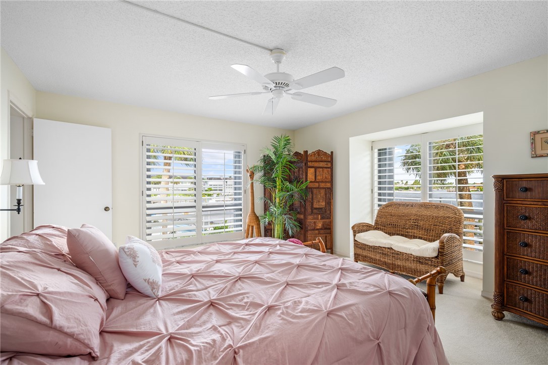 1875 Bay Road, Unit 215H Vero Beach, FL 32963 - Photo 14 of 36 a bedroom with a large bed and a window