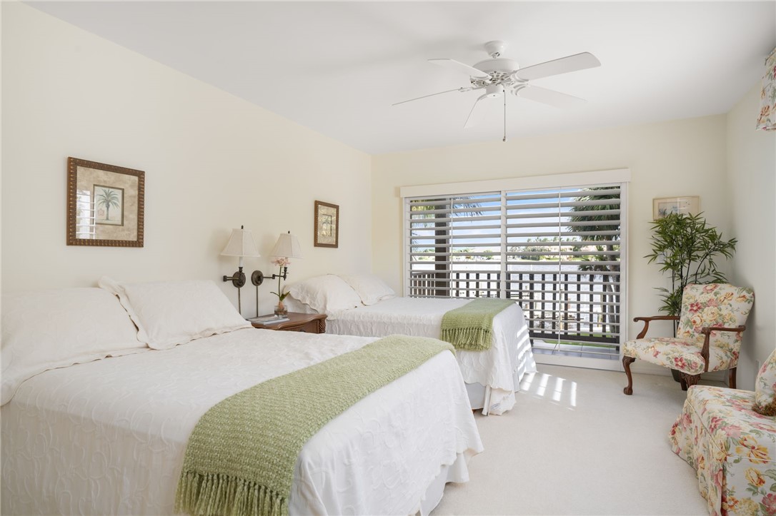 1875 Bay Road, Unit 215H Vero Beach, FL 32963 - Photo 17 of 36 a bedroom with furniture and a large window