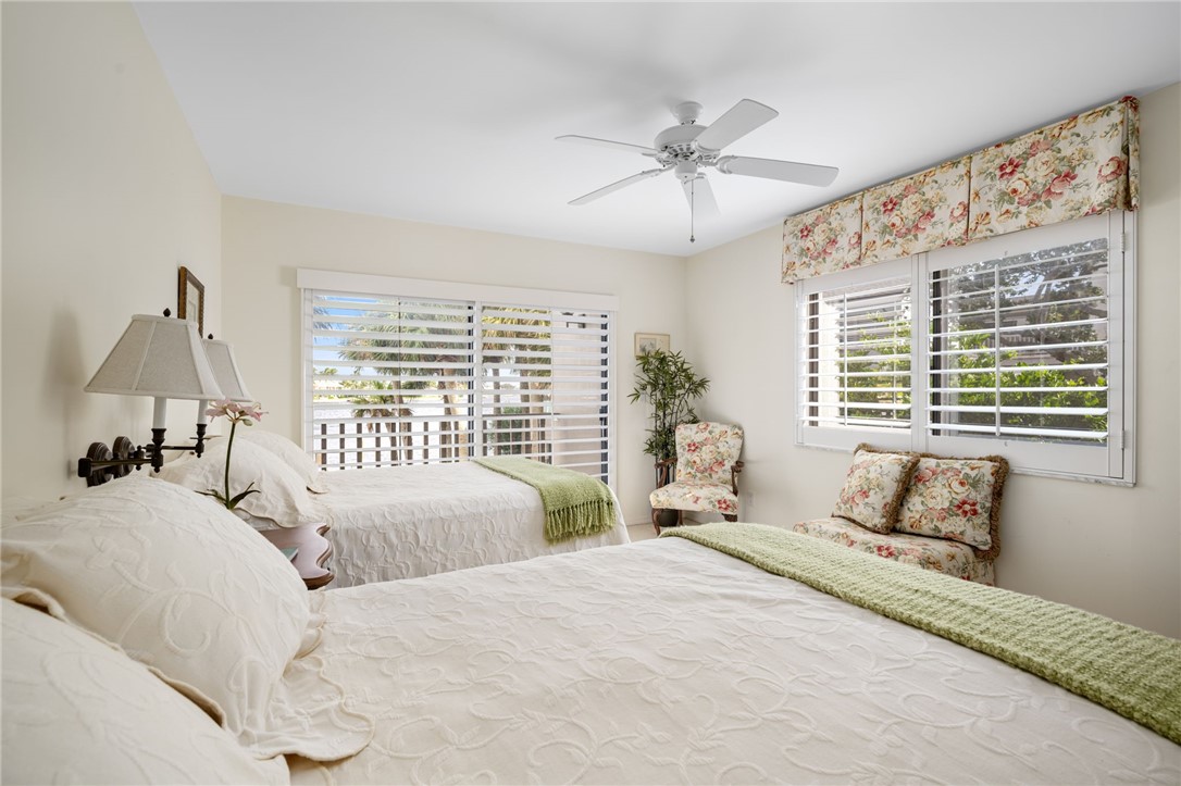 1875 Bay Road, Unit 215H Vero Beach, FL 32963 - Photo 18 of 36 a bedroom with a large bed and a window