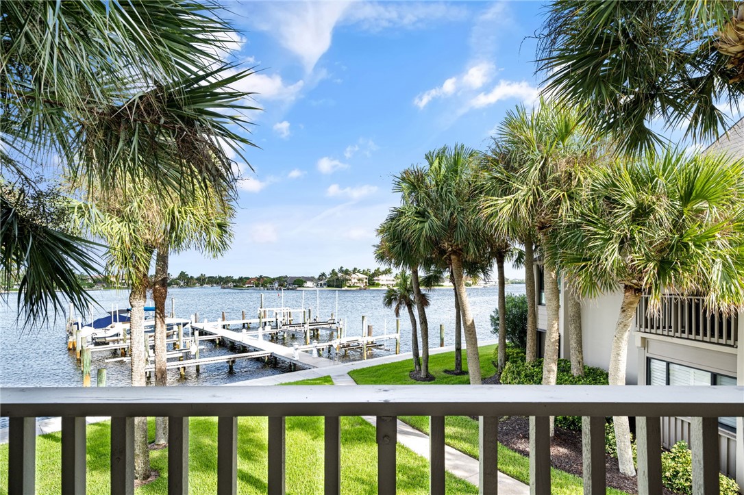 1875 Bay Road, Unit 215H Vero Beach, FL 32963 - Photo 20 of 36 a view of a swimming pool with a table and chairs