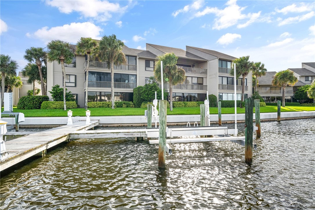 1875 Bay Road, Unit 215H Vero Beach, FL 32963 - Photo 24 of 36 a view of a house with a yard and plants