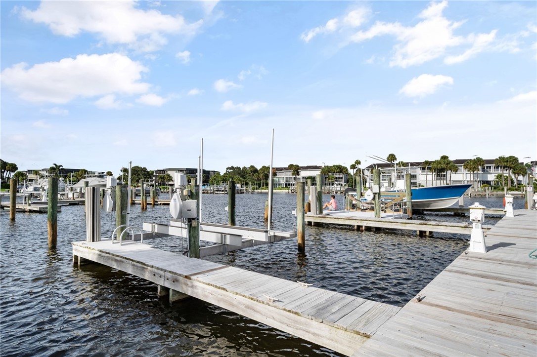 1875 Bay Road, Unit 215H Vero Beach, FL 32963 - Photo 25 of 36 a view of a terrace with wooden benches