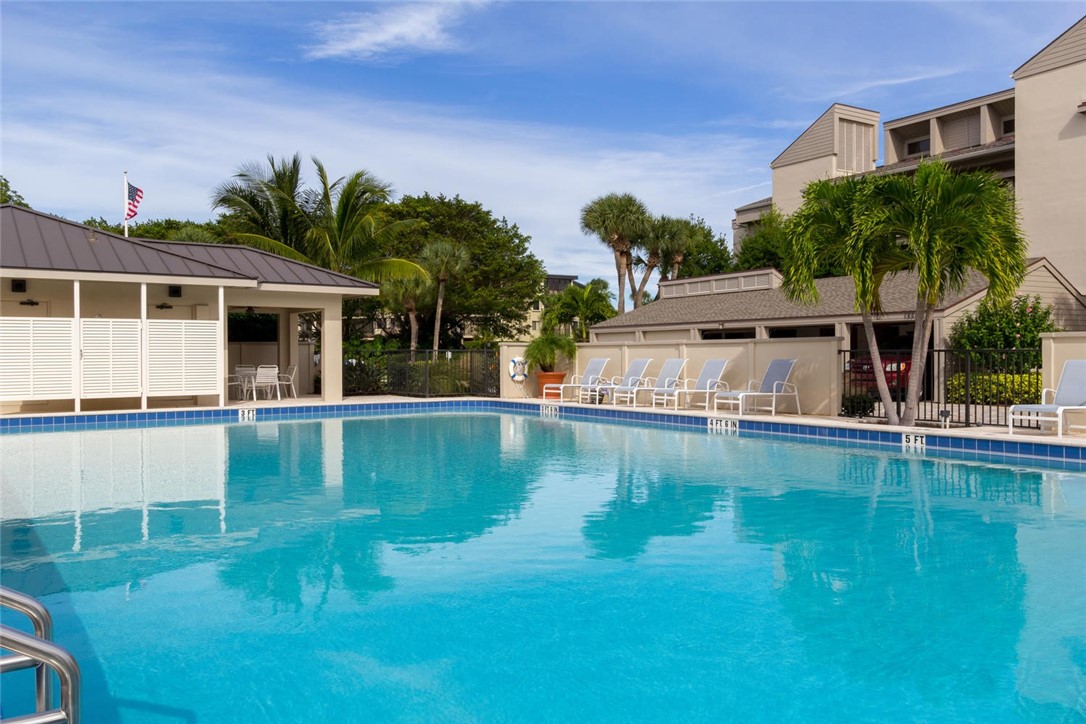 1875 Bay Road, Unit 215H Vero Beach, FL 32963 - Photo 29 of 36 a view of a house with pool and a yard