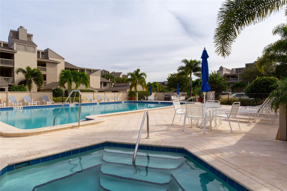 1875 Bay Road, Unit 215H Vero Beach, FL 32963 - Photo 30 of 36 a view of swimming pool with outdoor seating