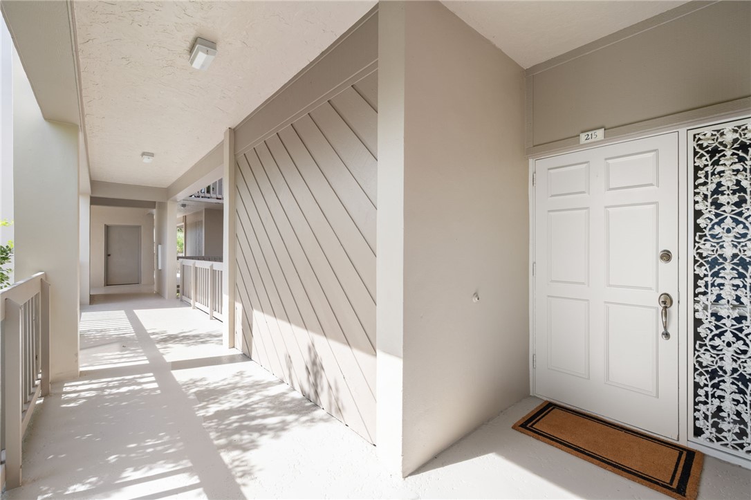 1875 Bay Road, Unit 215H Vero Beach, FL 32963 - Photo 3 of 36 a view of an entryway with wooden floor and door