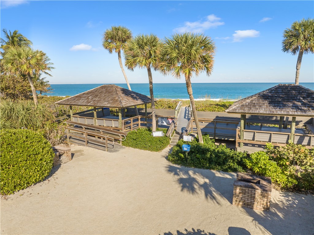 1875 Bay Road, Unit 215H Vero Beach, FL 32963 - Photo 34 of 36 a house with palm tree in front of it
