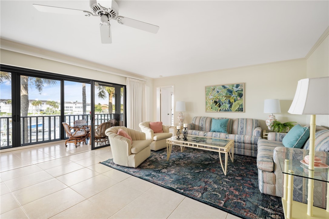 1875 Bay Road, Unit 215H Vero Beach, FL 32963 - Photo 4 of 36 a living room with furniture and a large window