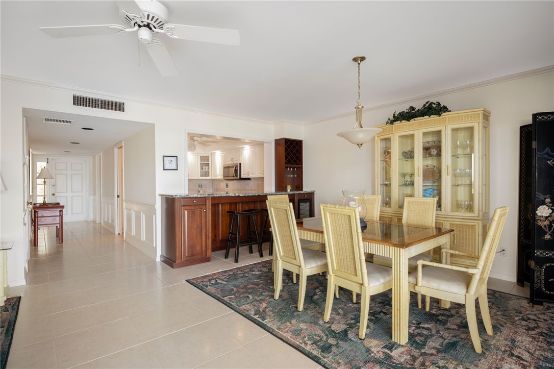 1875 Bay Road, Unit 215H Vero Beach, FL 32963 - Photo 6 of 36 a dining room with furniture and window