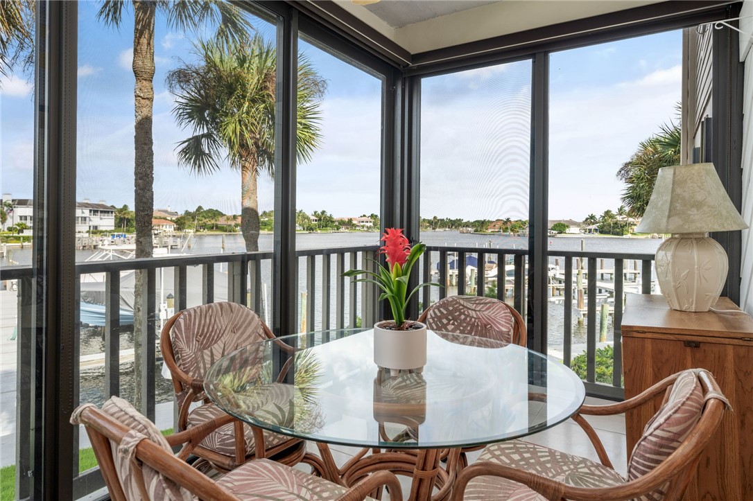 1875 Bay Road, Unit 215H Vero Beach, FL 32963 - Photo 10 of 36 a dining room with furniture window and outside view