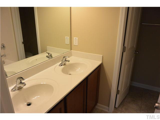 5009 Lalex Lane Cary, NC 27519 - Photo 13 of 15 a bathroom with a sink and a mirror